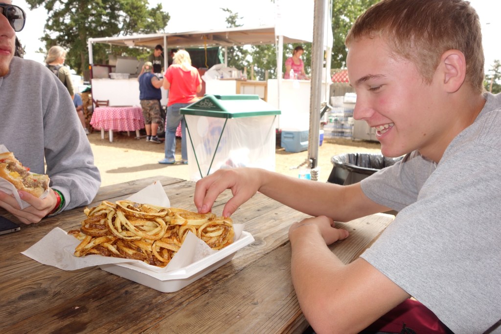Festus eating fried onion rings at a county fair the weekend we spread his grammy's ashes in San Juan channel